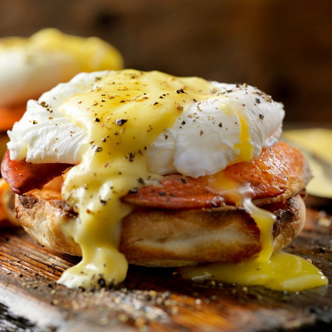 Eggs Benedict with hollandaise sauce, on an English muffin.