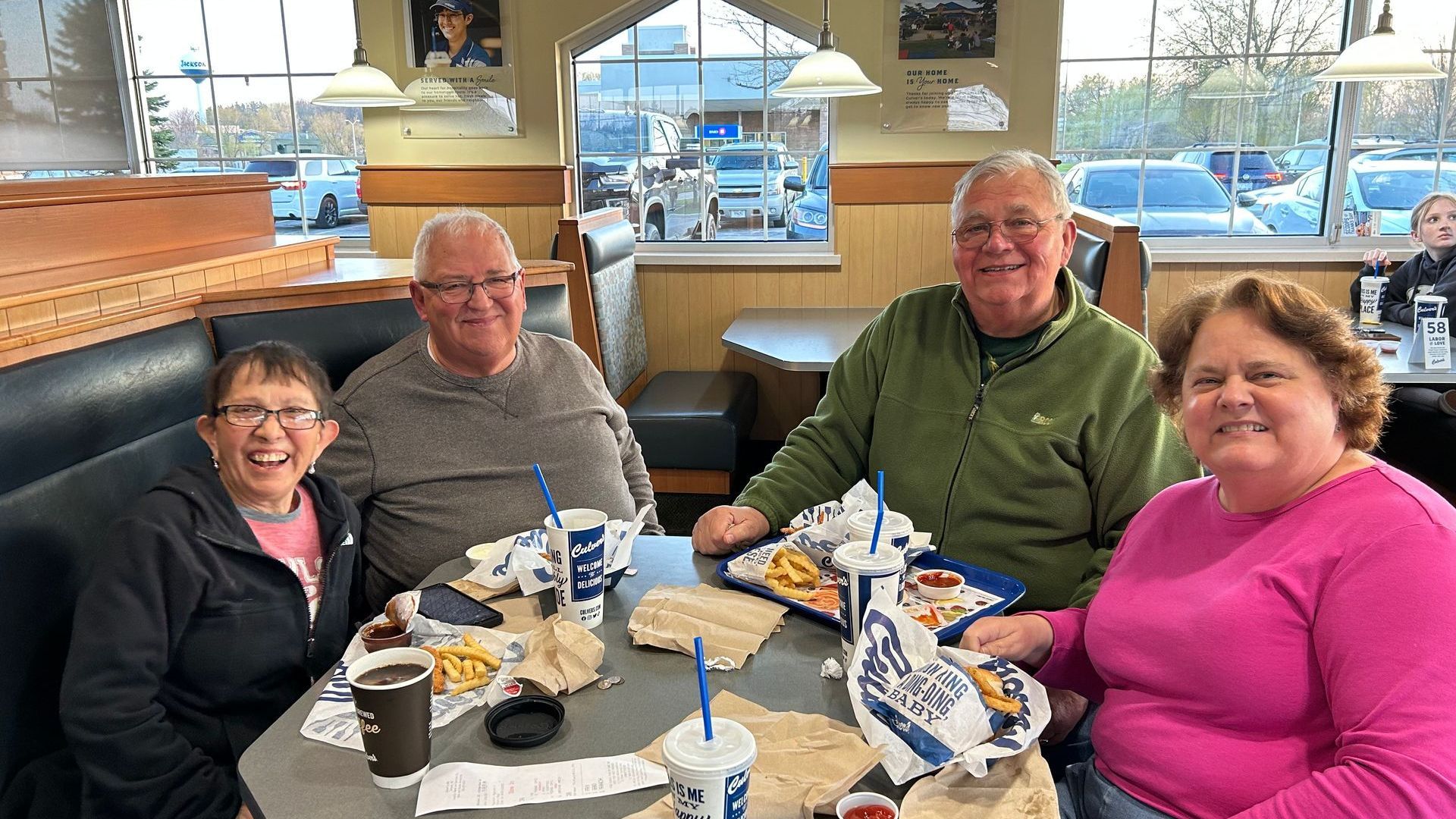 A group of people are sitting at a table in Culver's at a Youth Fundraiser.