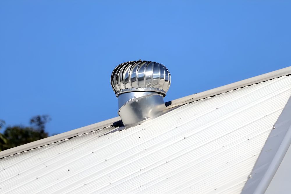 A White Roof With A Wind Turbine On Top Of It — The Gutter Guy NSW in Tarrawanna, NSW