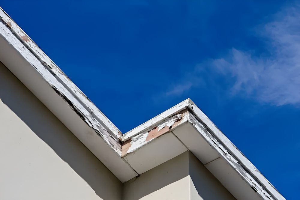 Looking Up At The Roof Of A Building With A Blue Sky — The Gutter Guy NSW in Tarrawanna, NSW