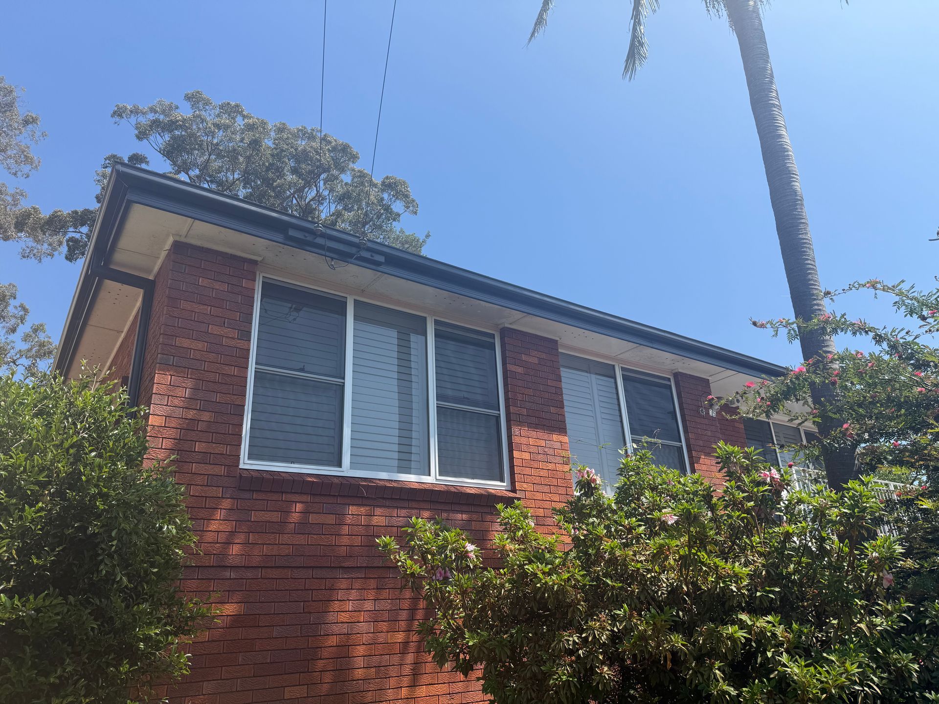 A Red Brick House With A New Gutter — The Gutter Guy NSW in Shellharbour, NSW
