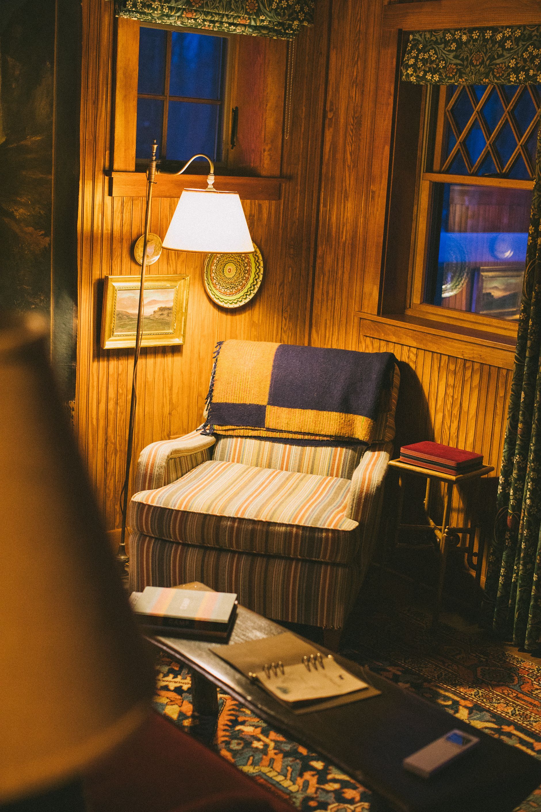 A living room with a chair and a lamp