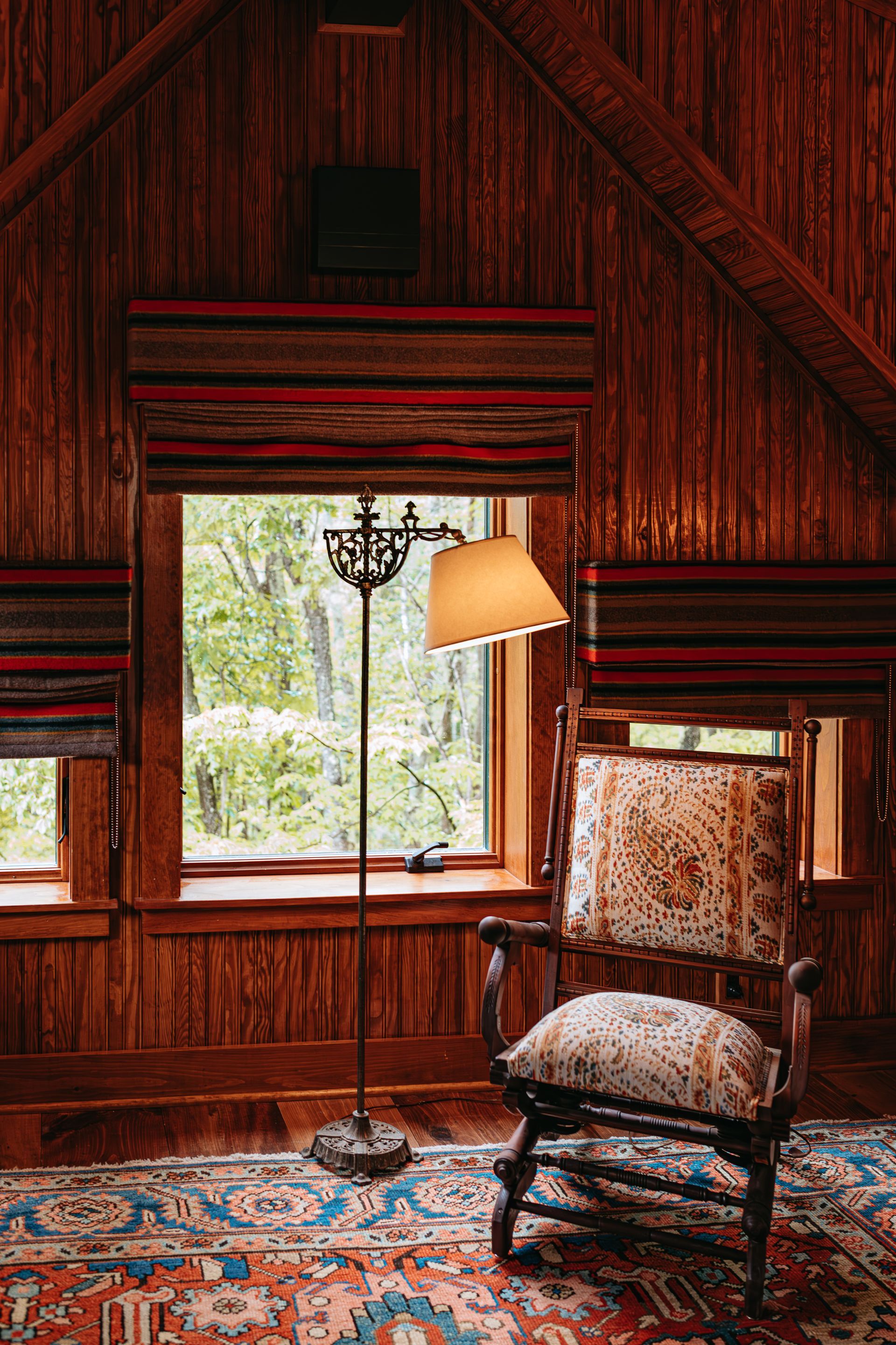 There is a chair and a lamp in the room.
