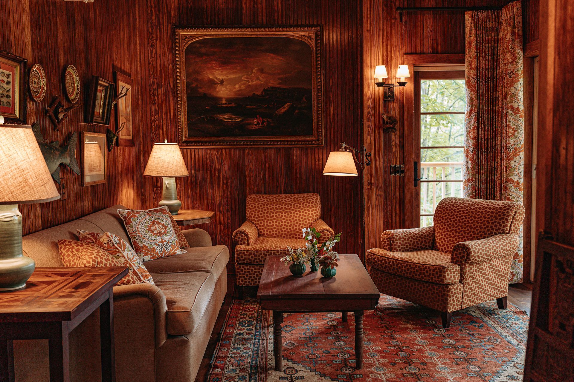A living room filled with furniture and a painting on the wall.