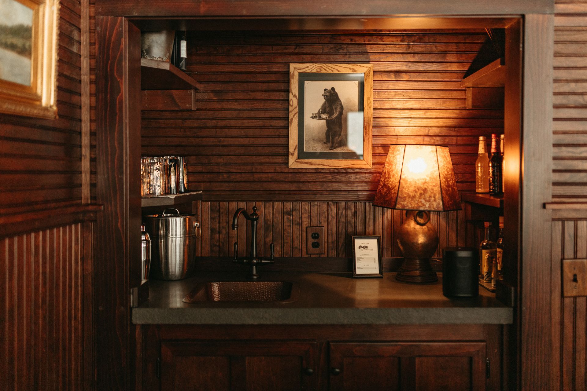 There is a picture of a bear on the wall above the bar.