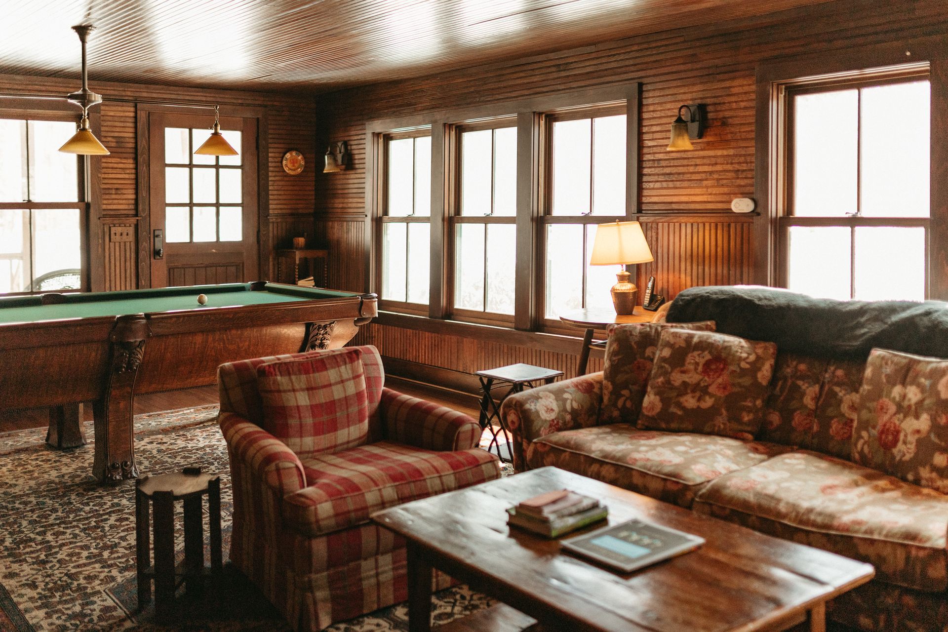 A living room filled with furniture and a pool table.