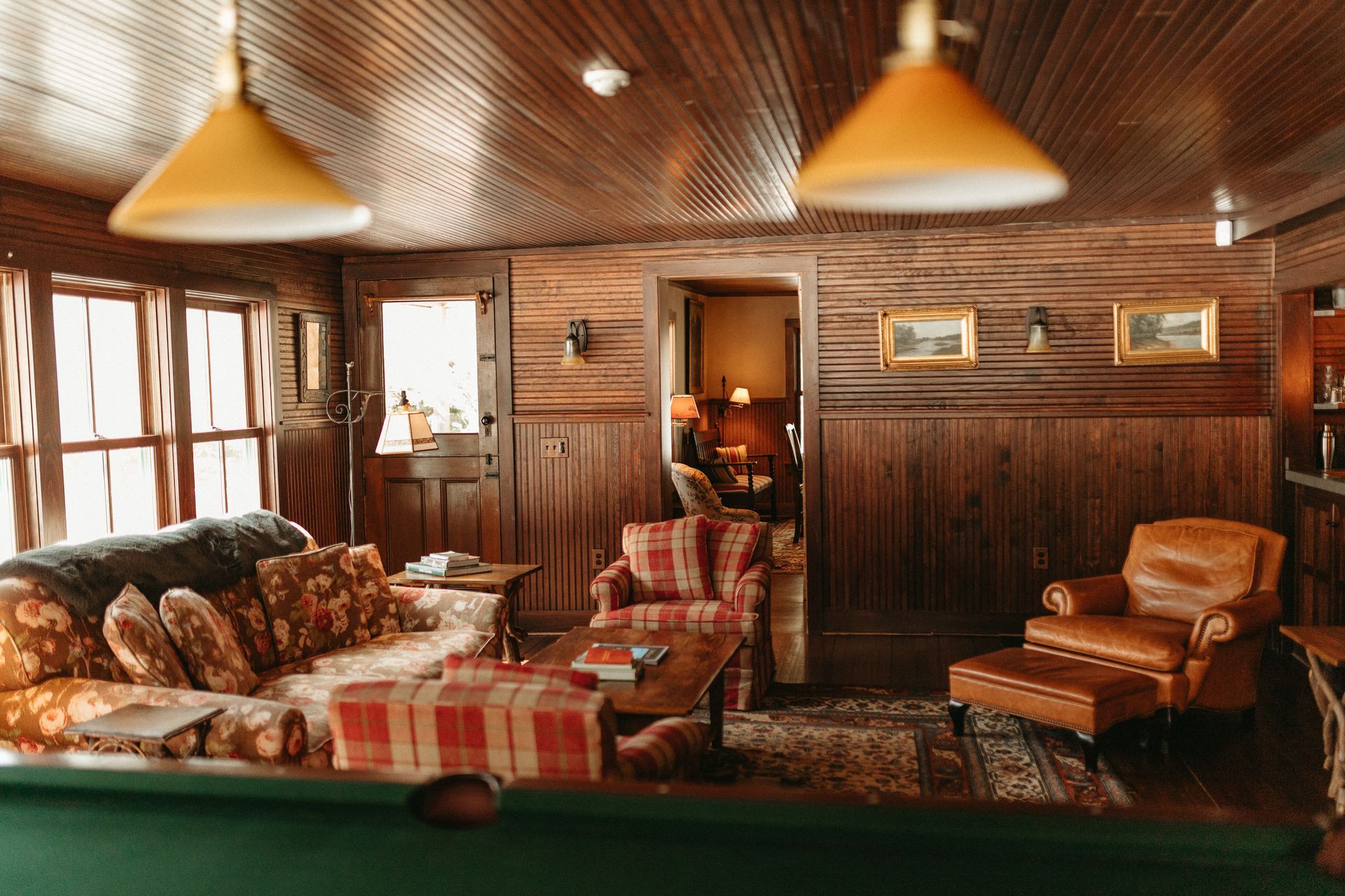A living room filled with furniture and a pool table.