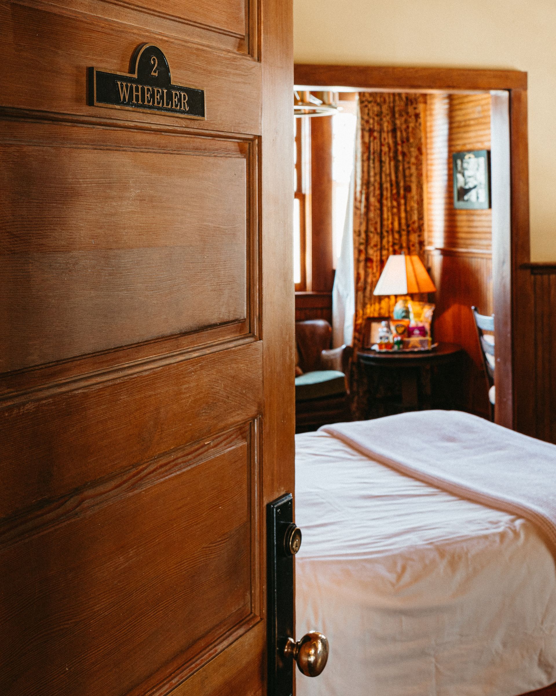 A hotel room with a sign on the door that says wisconsin