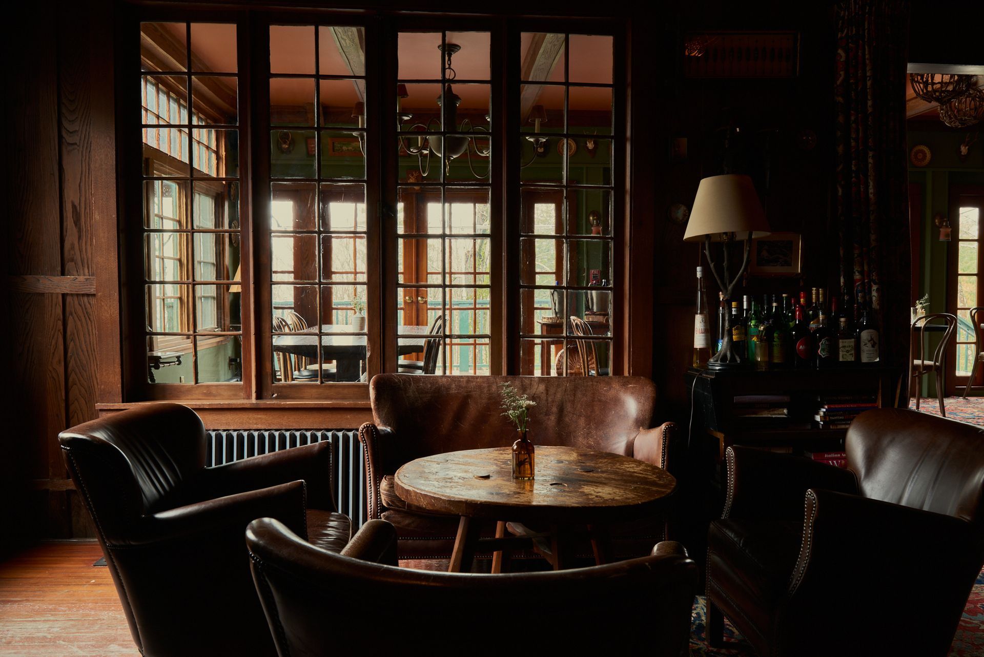 There is a table and chairs in the middle of the room.