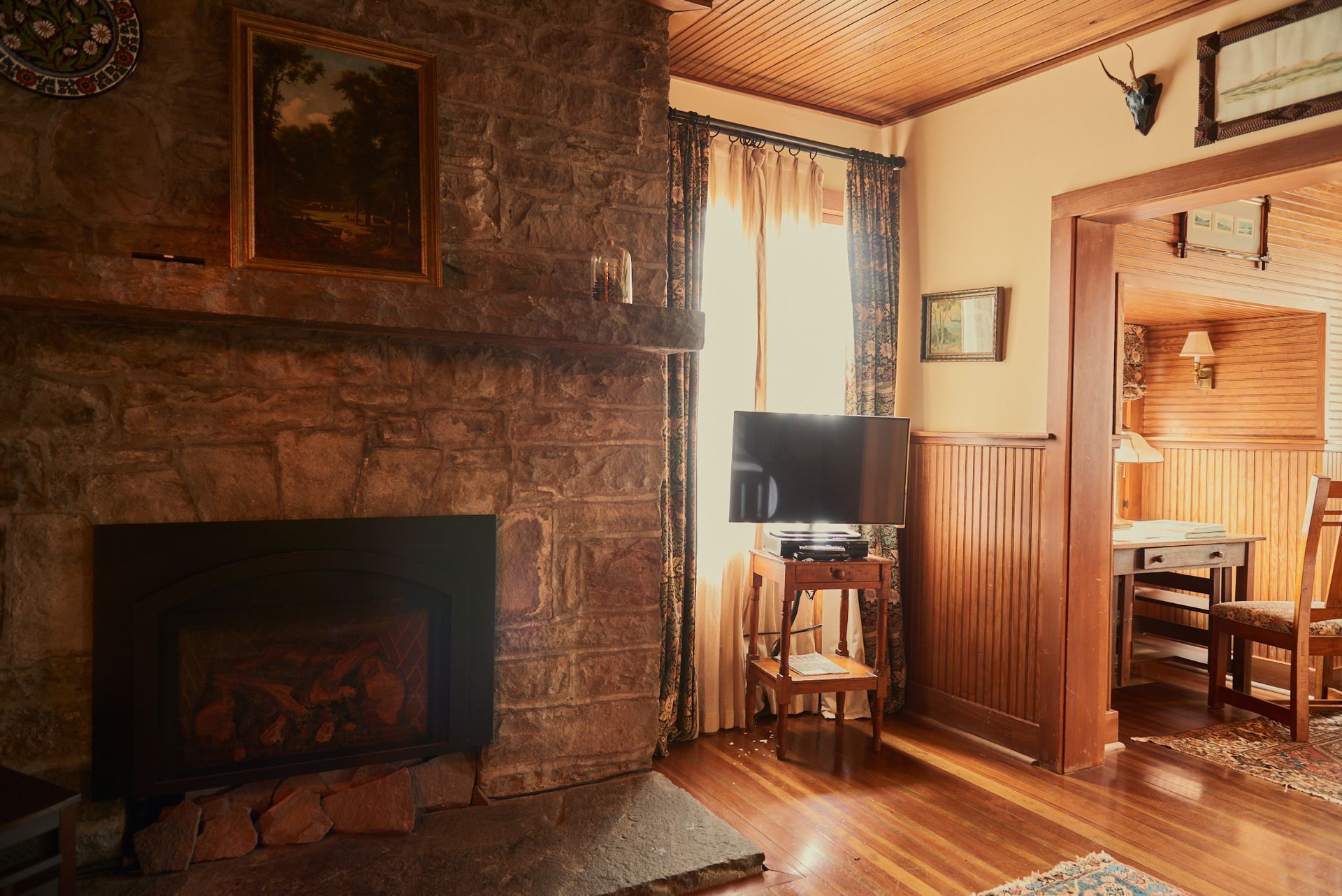A living room with a fireplace and a television.