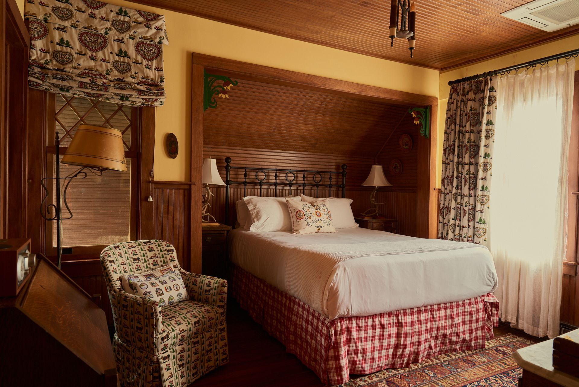 A bedroom with a king size bed and a chair