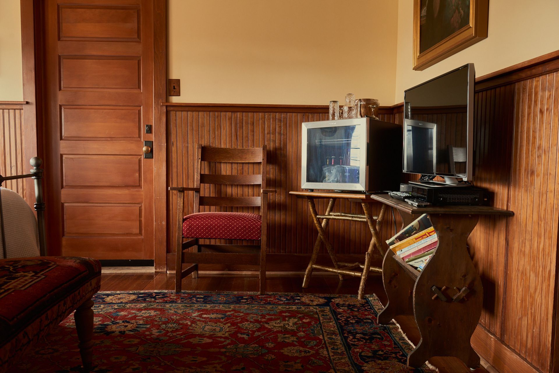 A living room with a chair and a television