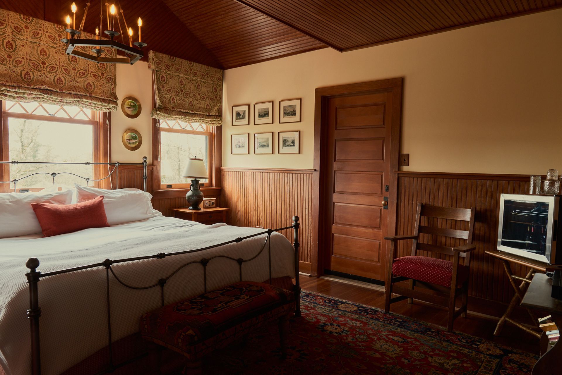A bedroom with a large bed and a chair
