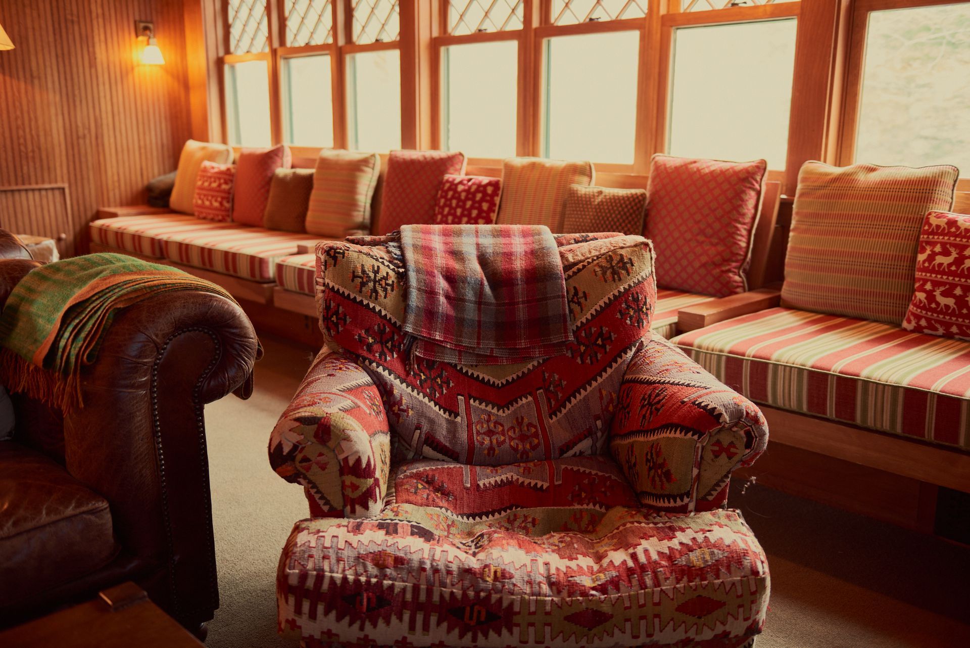 A chair in a living room with a blanket on it