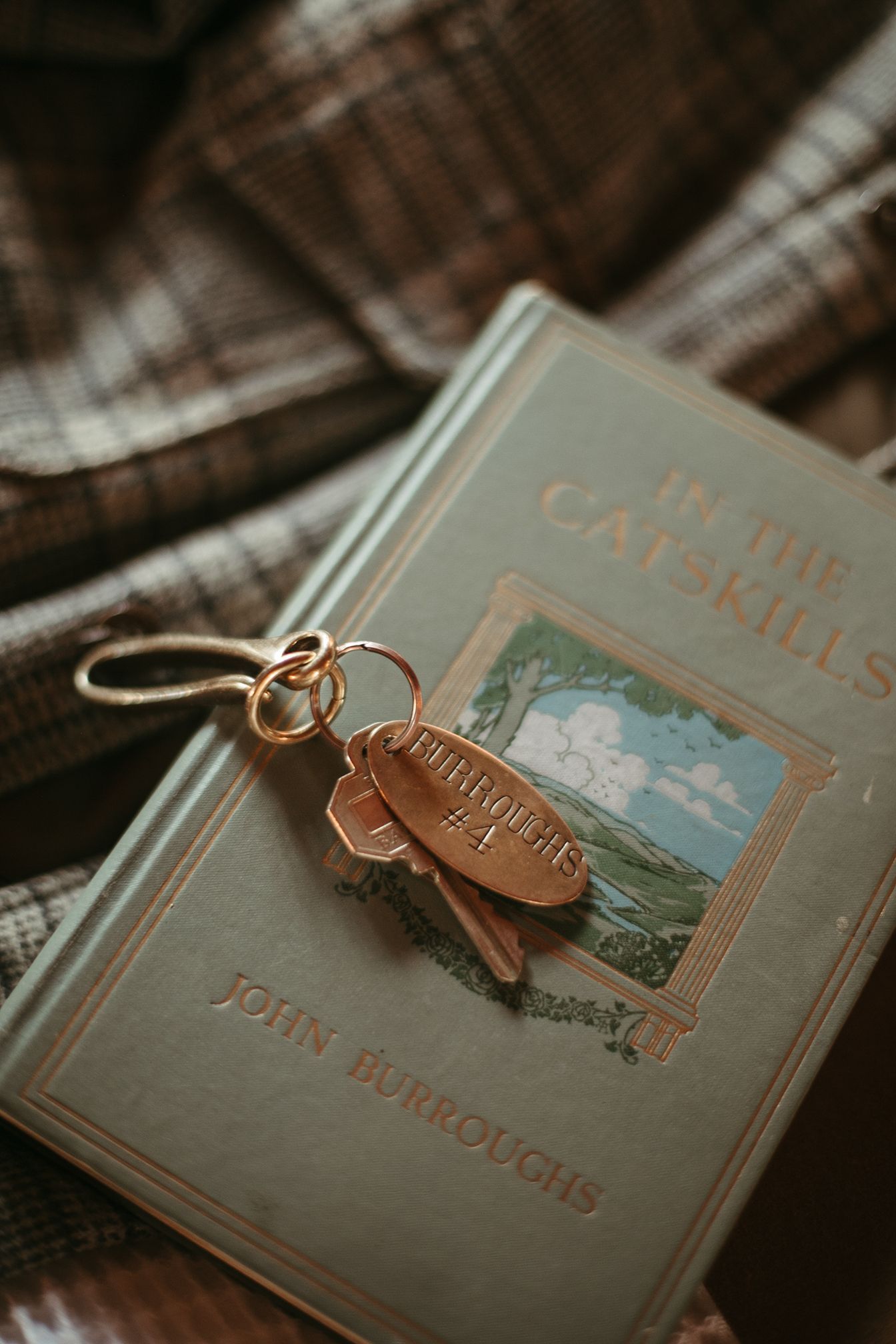 A keychain is sitting on top of a book.