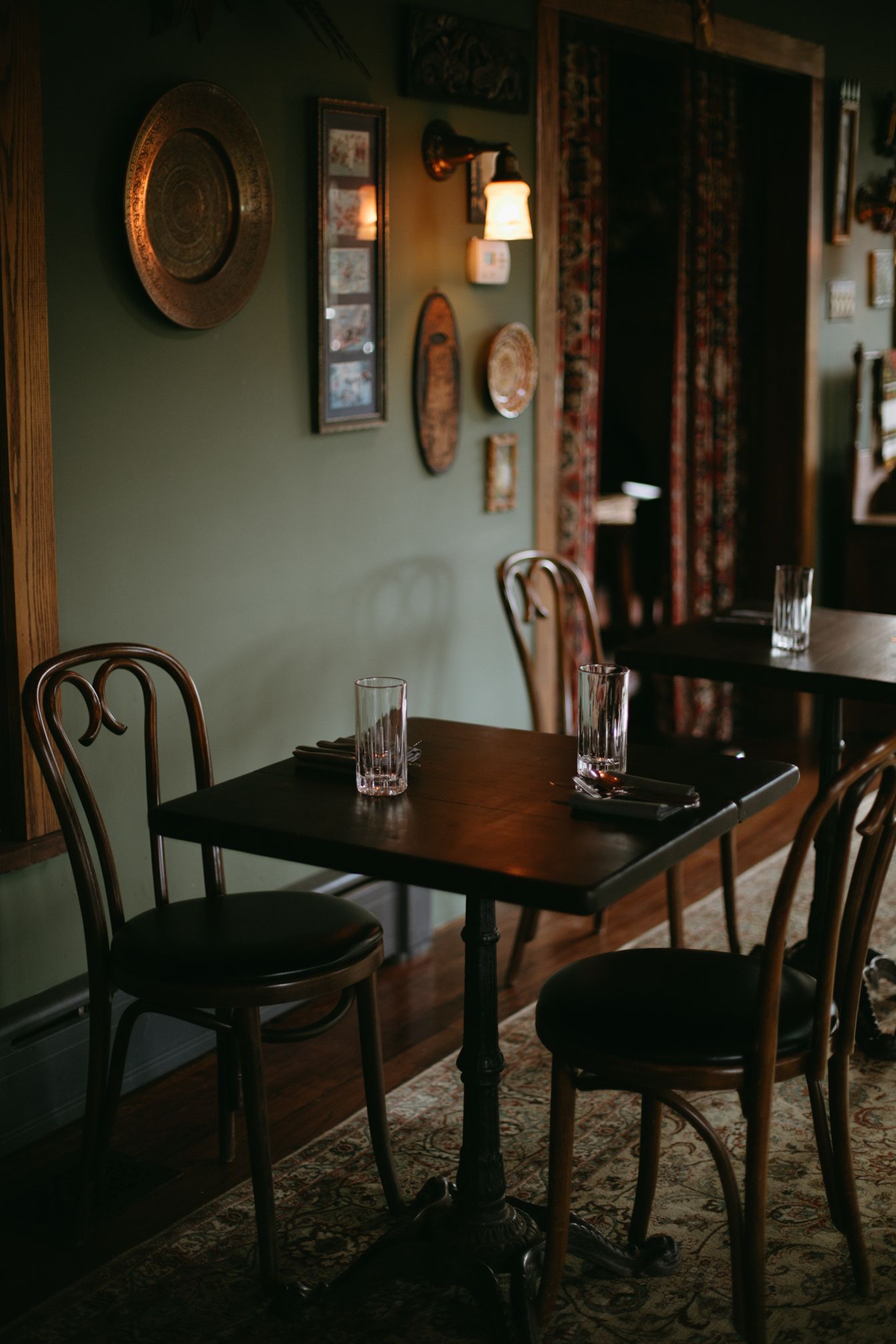 There are two tables and chairs in the room.