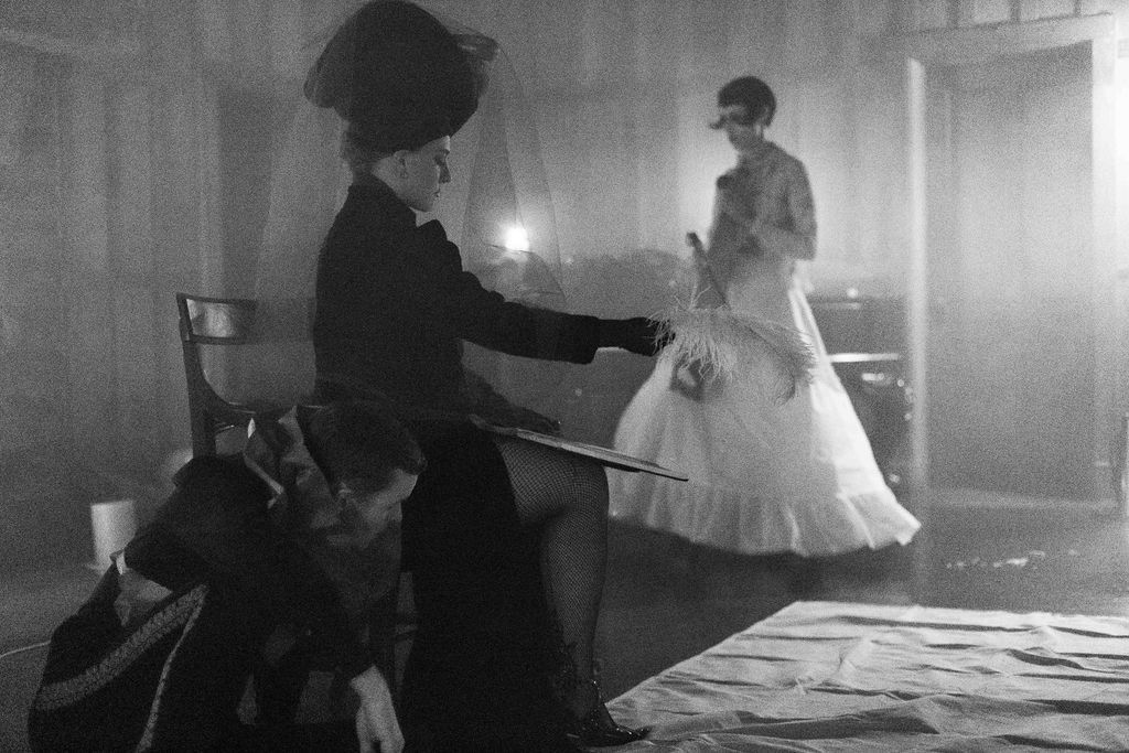 A black and white photo of two women standing next to each other in a room.