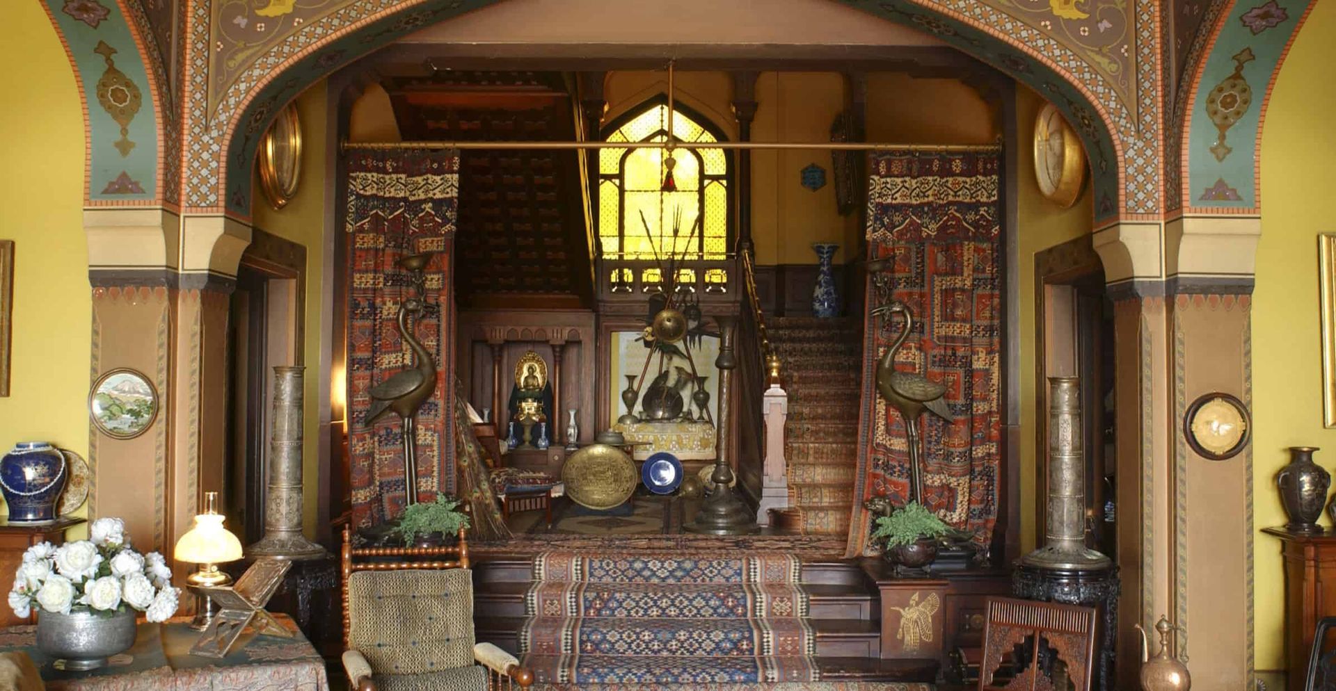 A room with a lot of furniture and a staircase