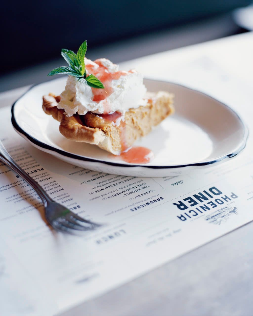 A phoenix diner menu with a pie on a plate