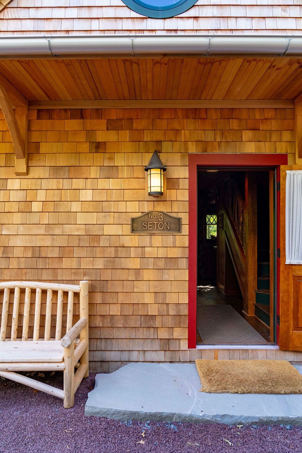 The front door of a house with a bench in front of it