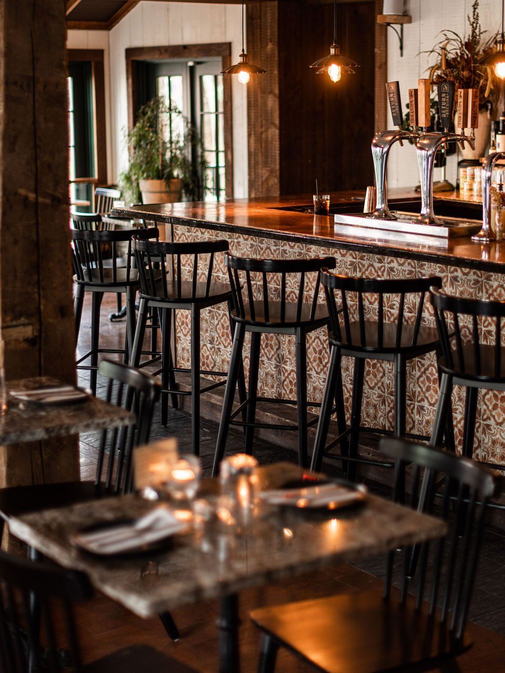 A restaurant with tables and chairs and a bar