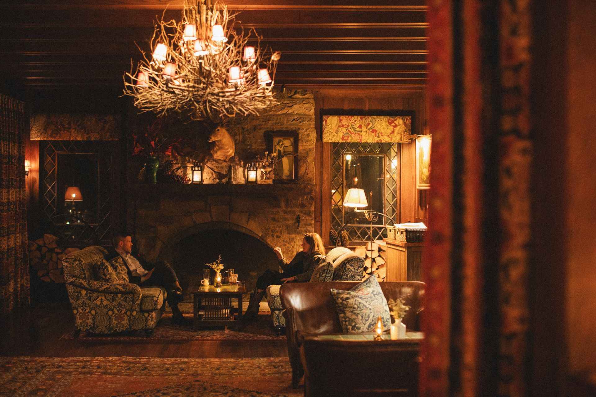 A living room with a fireplace and a chandelier.