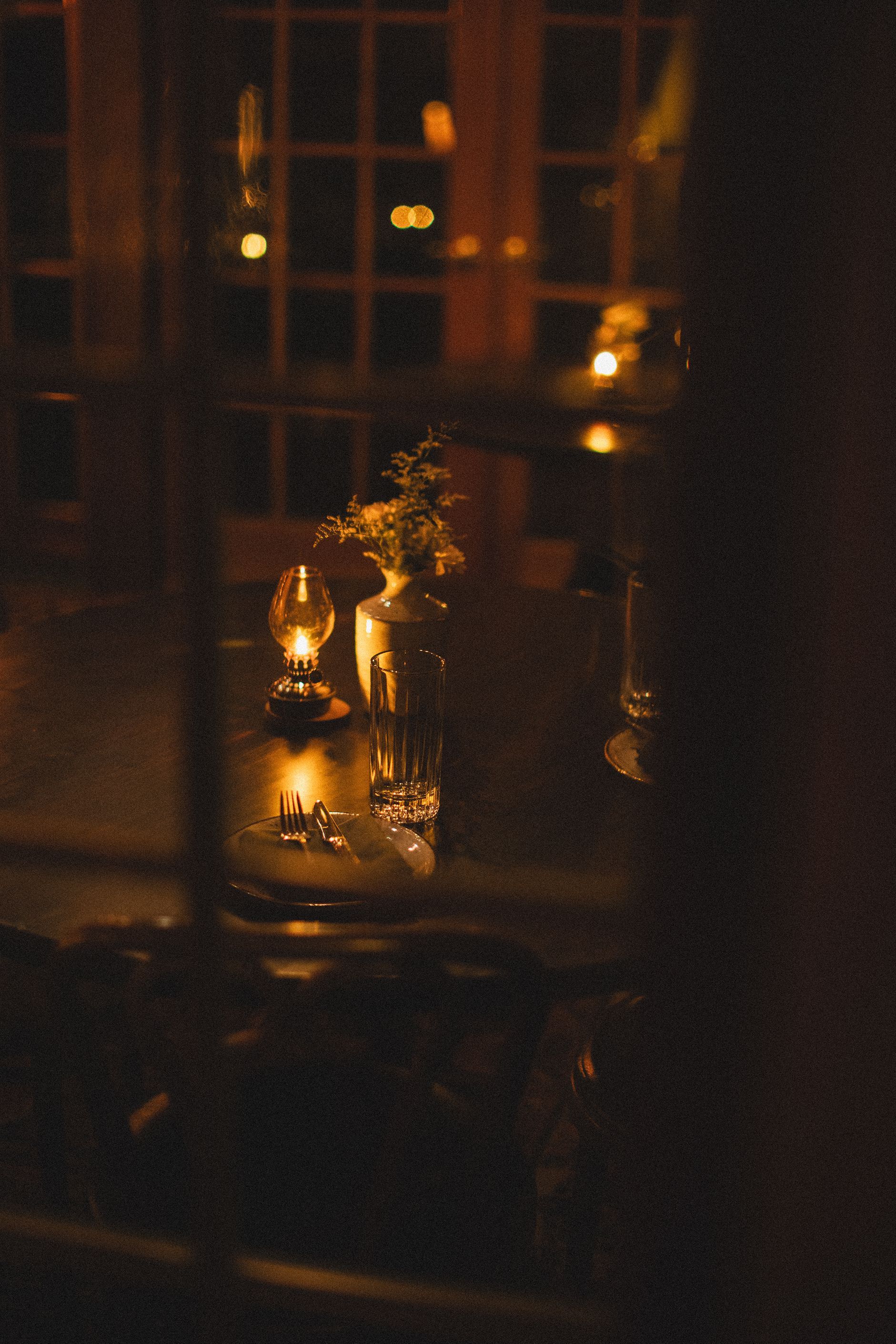 A table with candles on it in a dark room