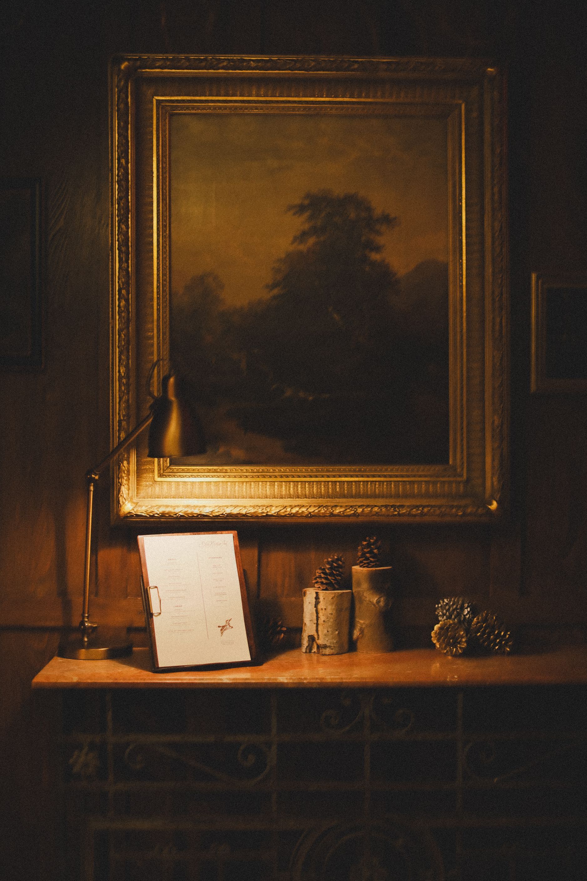 A painting is hanging on a wall above a table
