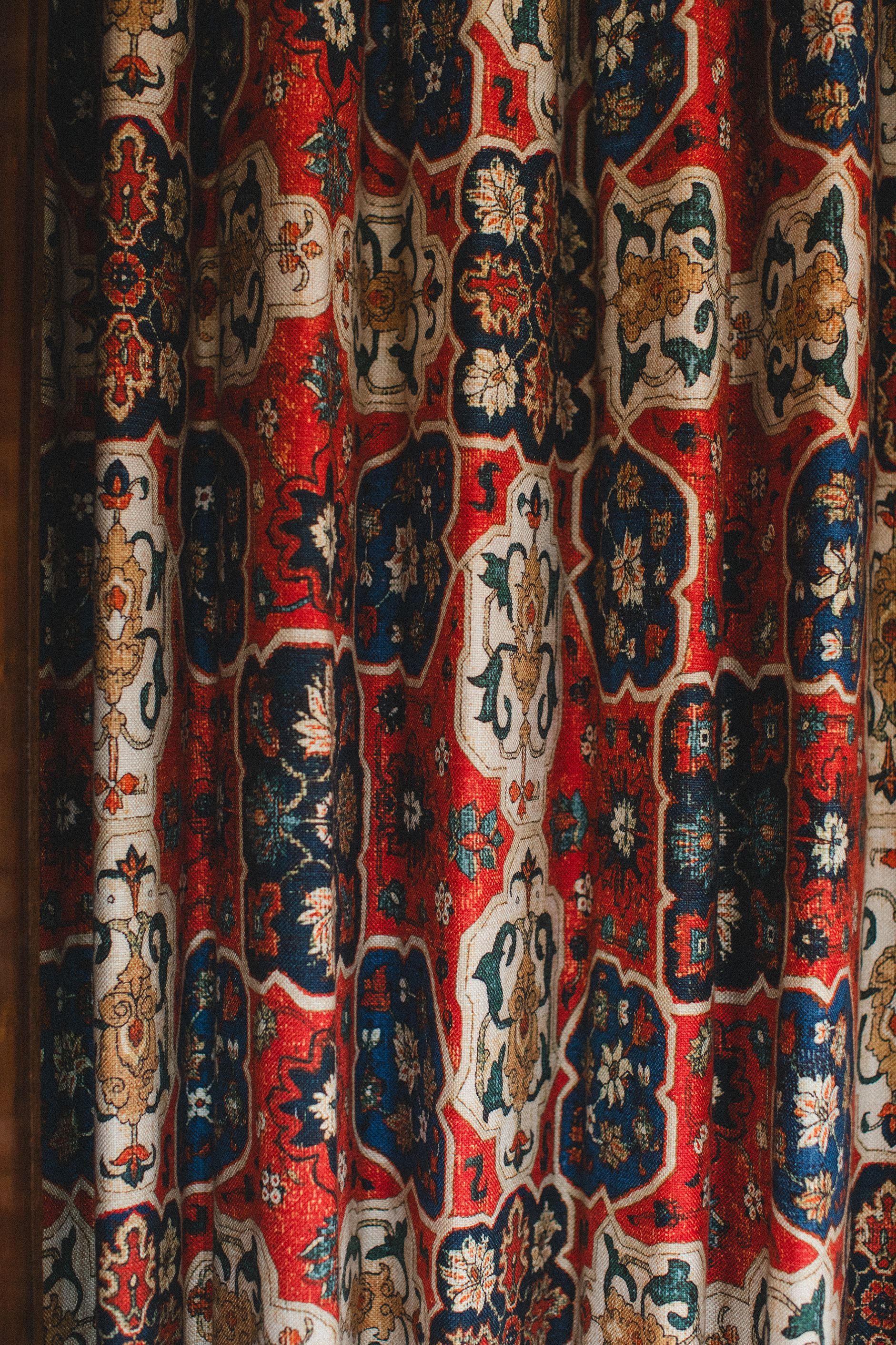 A close up of a curtain with a floral pattern on it.