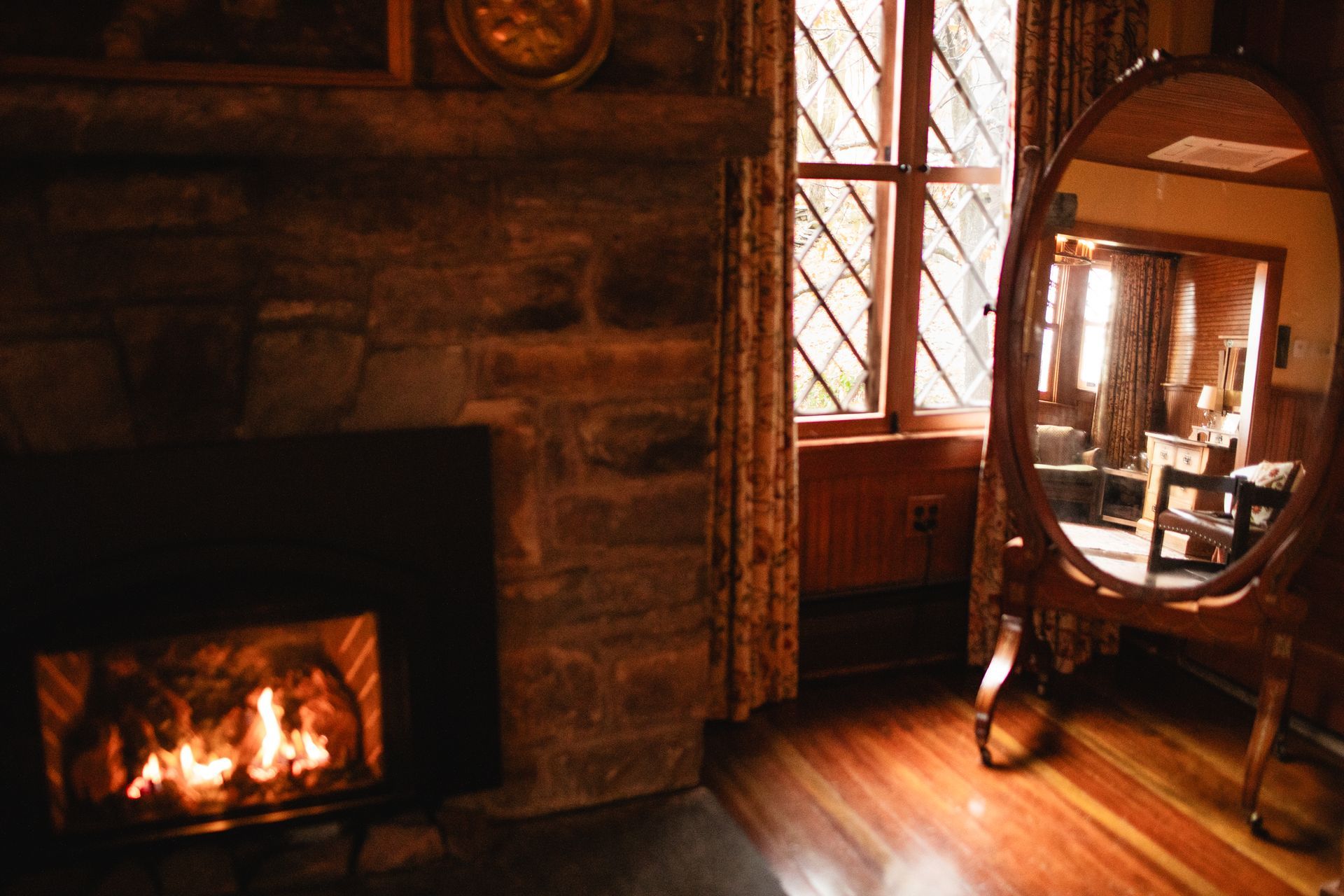 A living room with a fireplace and a mirror