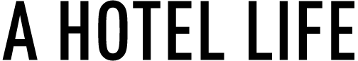 A black and white logo for a hotel life