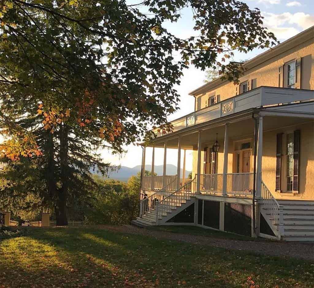 A large house with a large porch and stairs