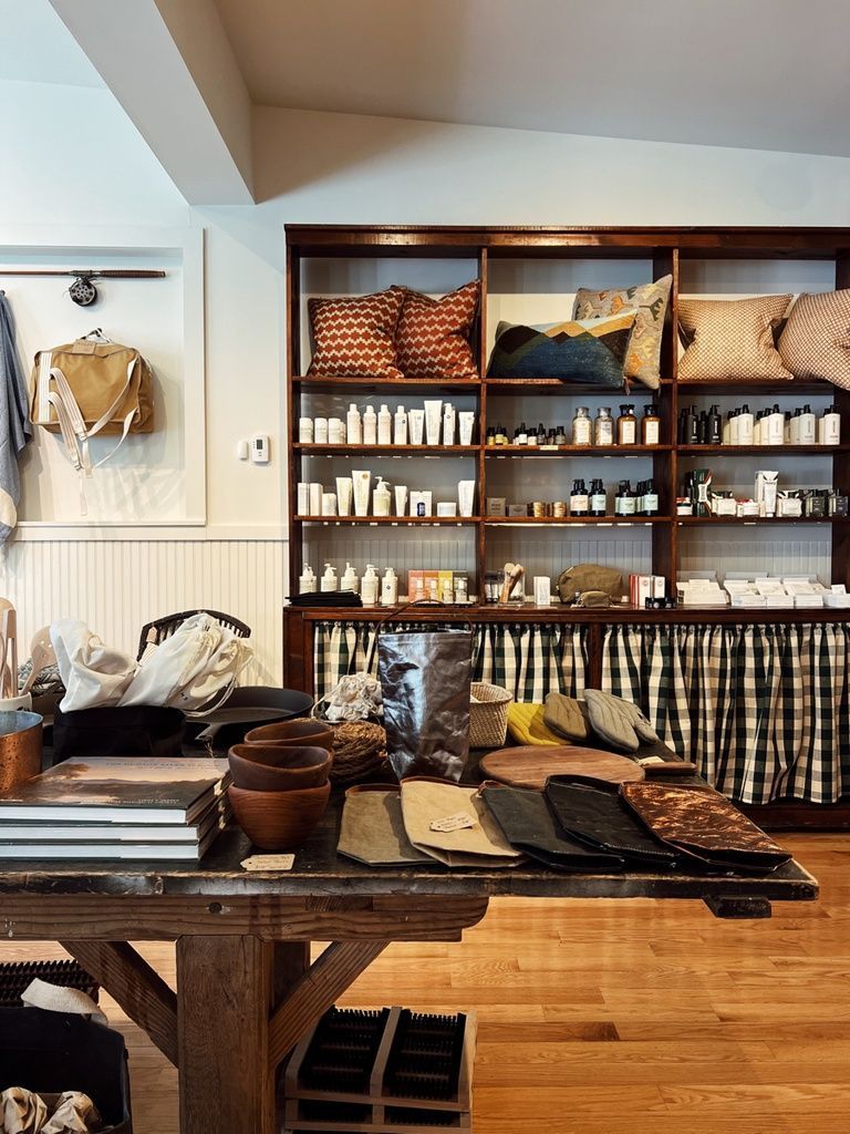 A store with lots of shelves and a table