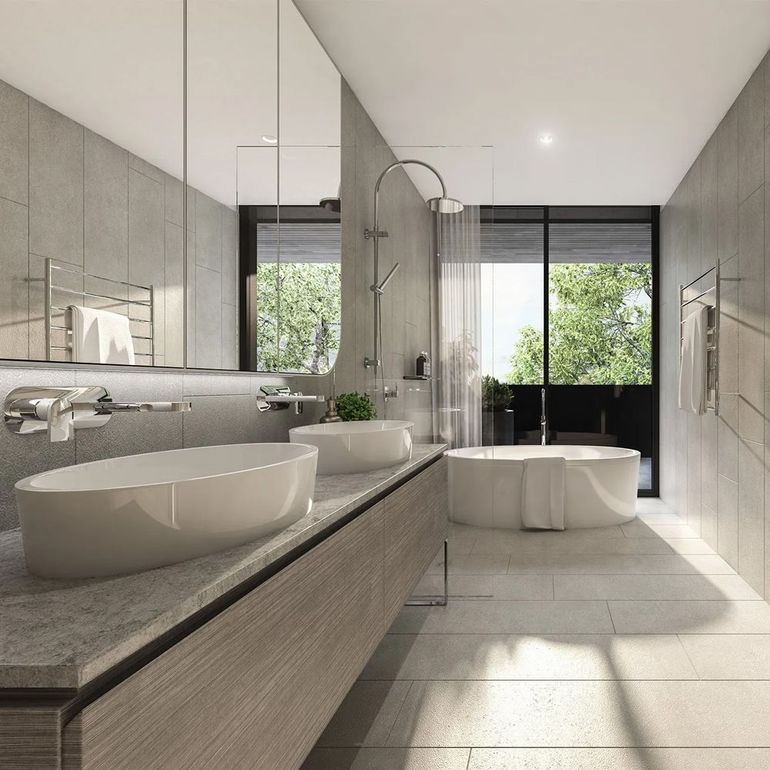 Modern minimalist bathroom with double sinks, freestanding tub, large mirrors, and bright natural light