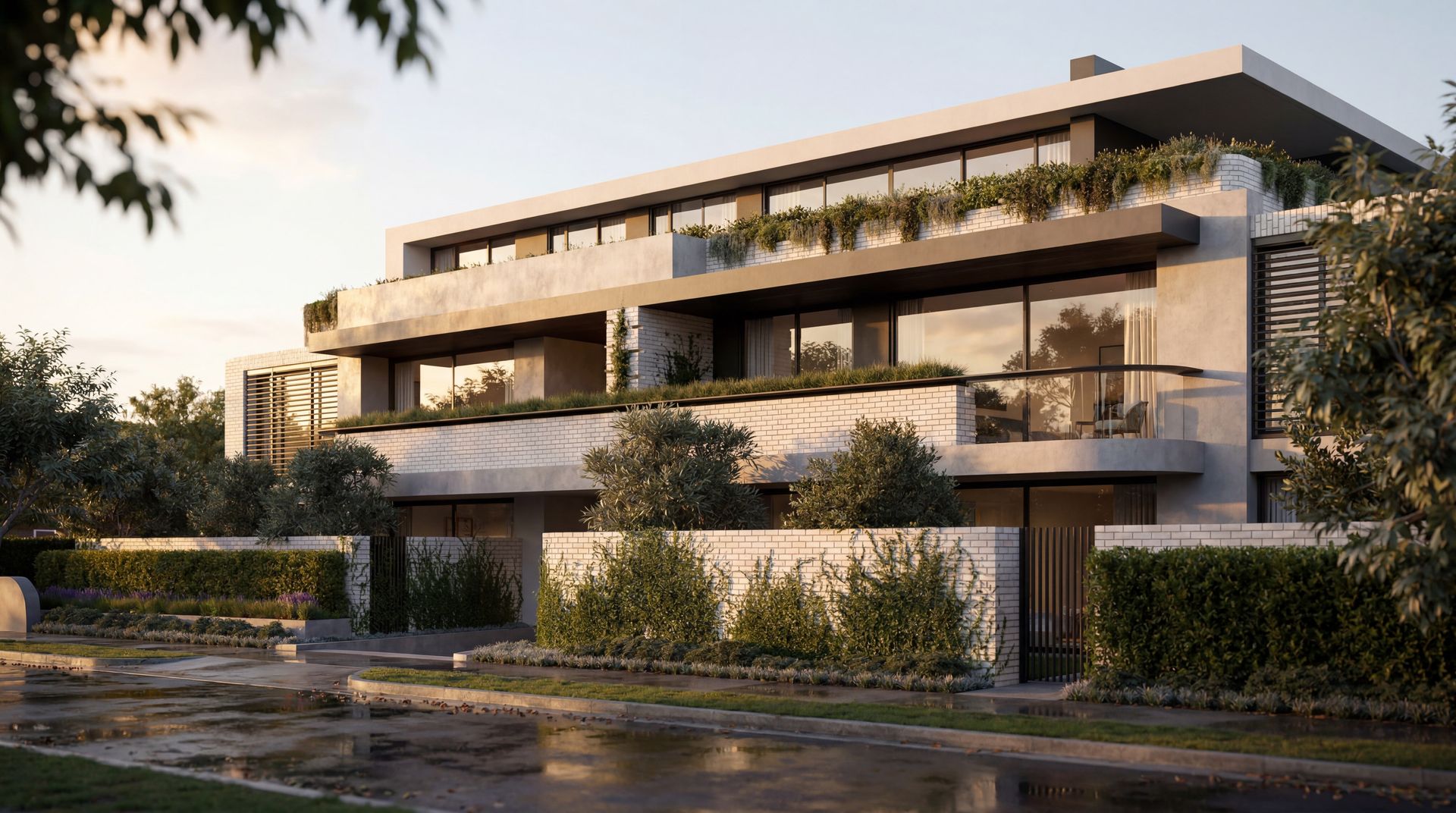 Modern multi-story apartment building with balconies and greenery at sunset