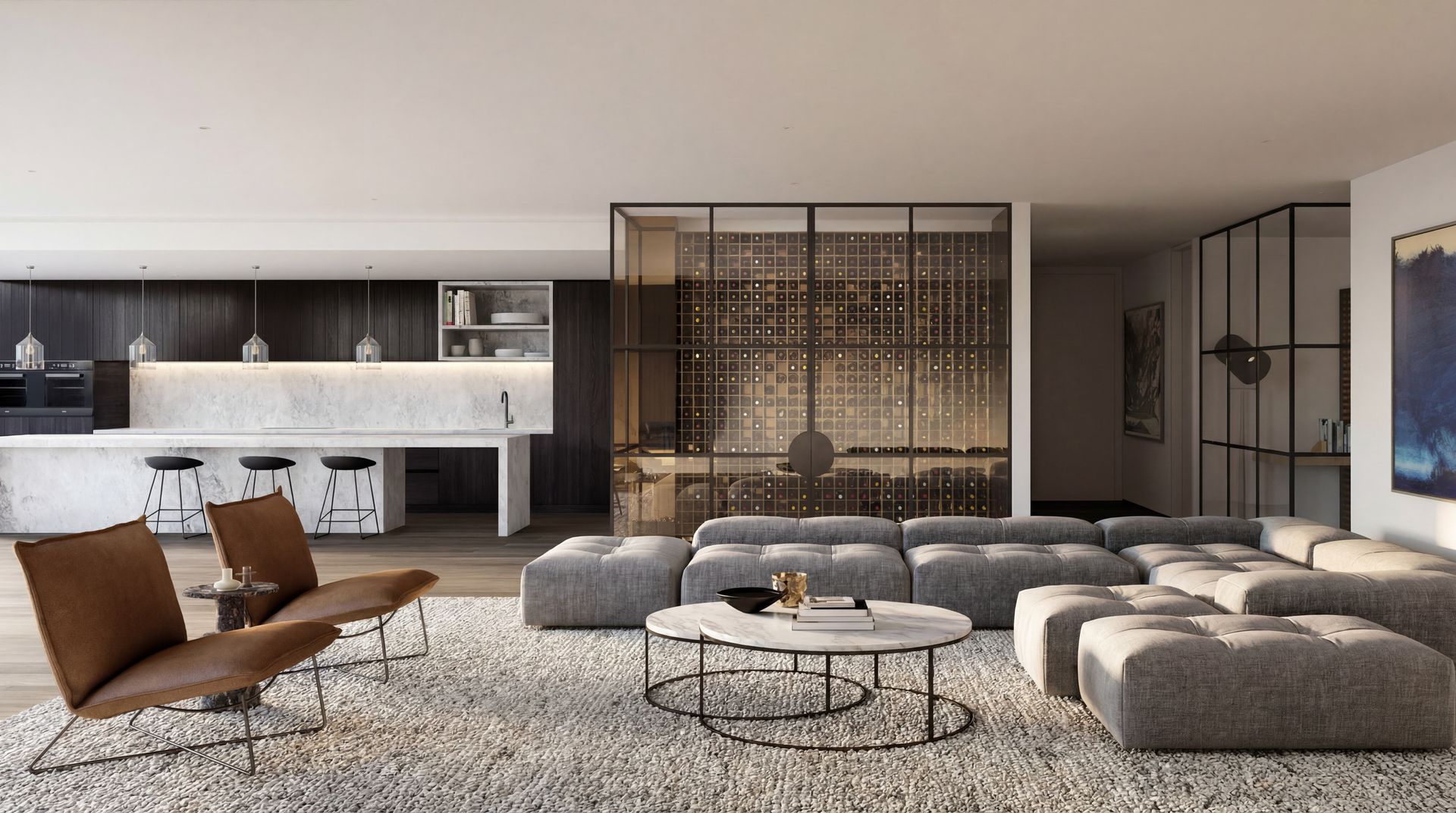 Modern living room with gray sectional sofas, brown lounge chairs, and a kitchen bar in the background