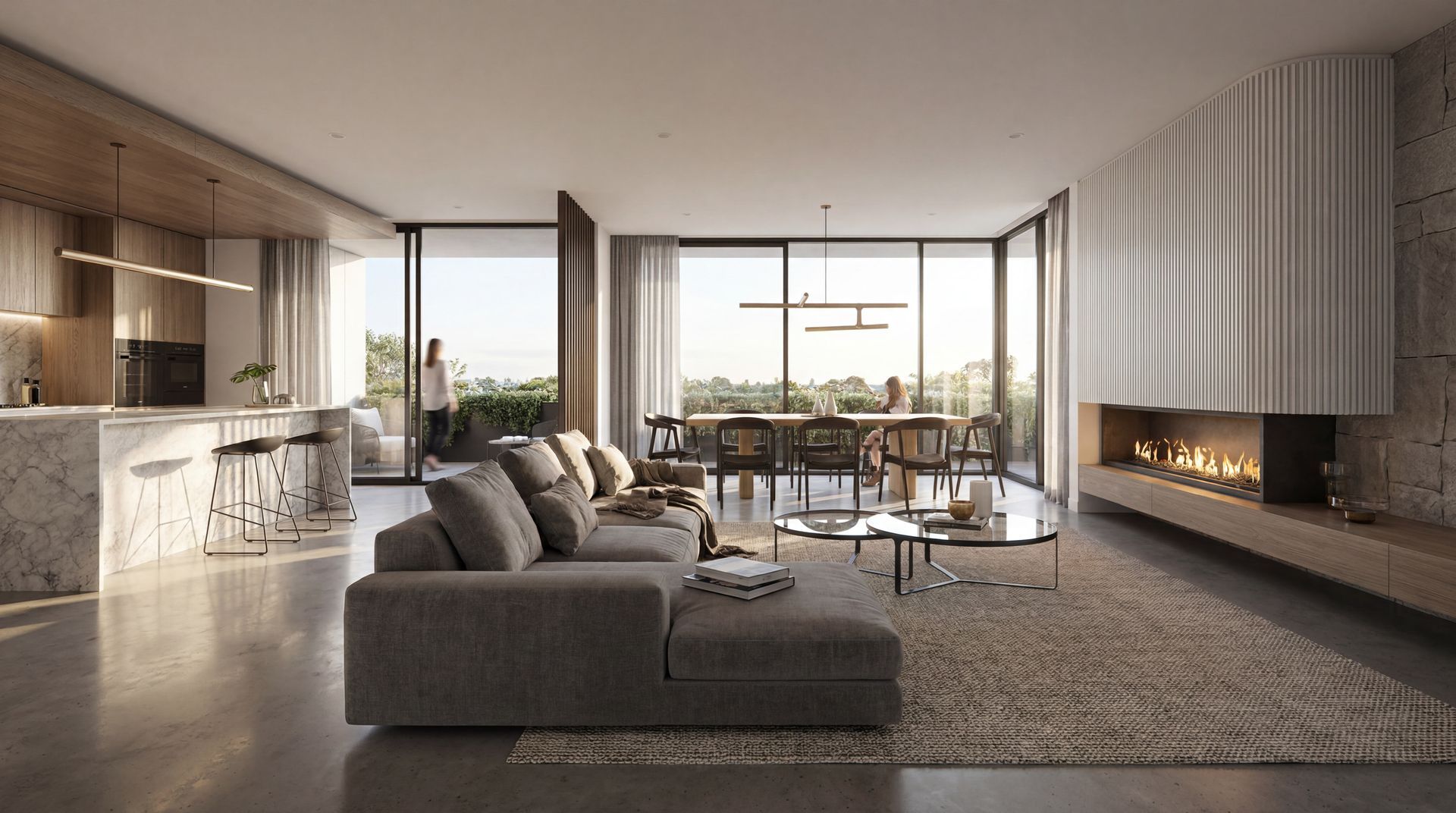 Modern open-plan living room with gray sectional, fireplace, and floor-to-ceiling windows overlooking a city view