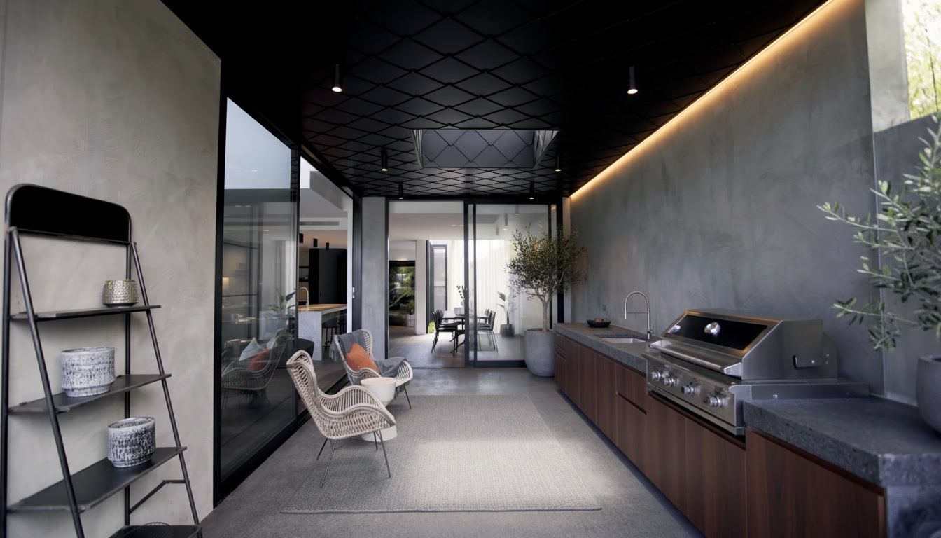 Modern open-air lounge with dark ceiling, gray seating, wall shelf, and long sideboard with plants