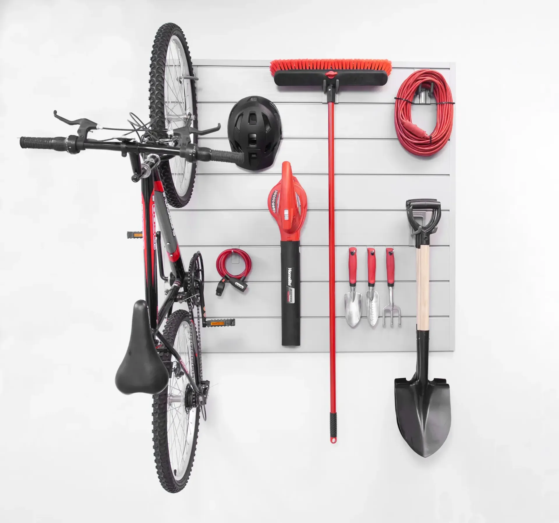 A bicycle is hanging on a wall surrounded by tools.