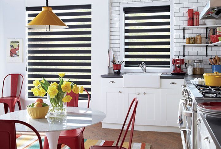 A kitchen with a table , chairs , and a sink.
