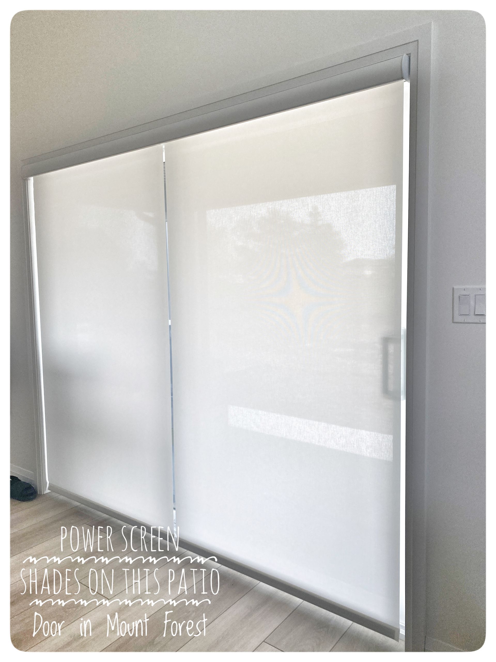A room with a large window with white blinds on it
