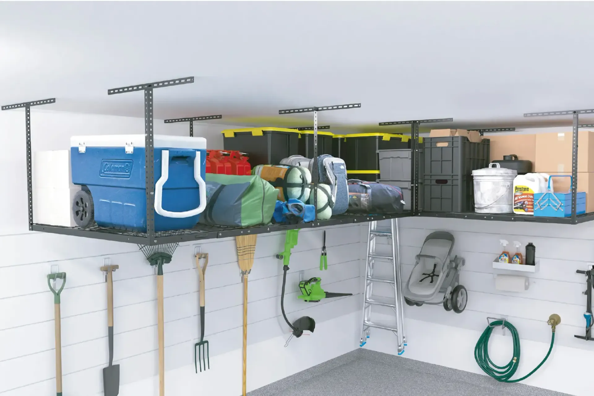 Organized garage storage shelves with cleaning supplies, tools, and gardening equipment above a workbench.