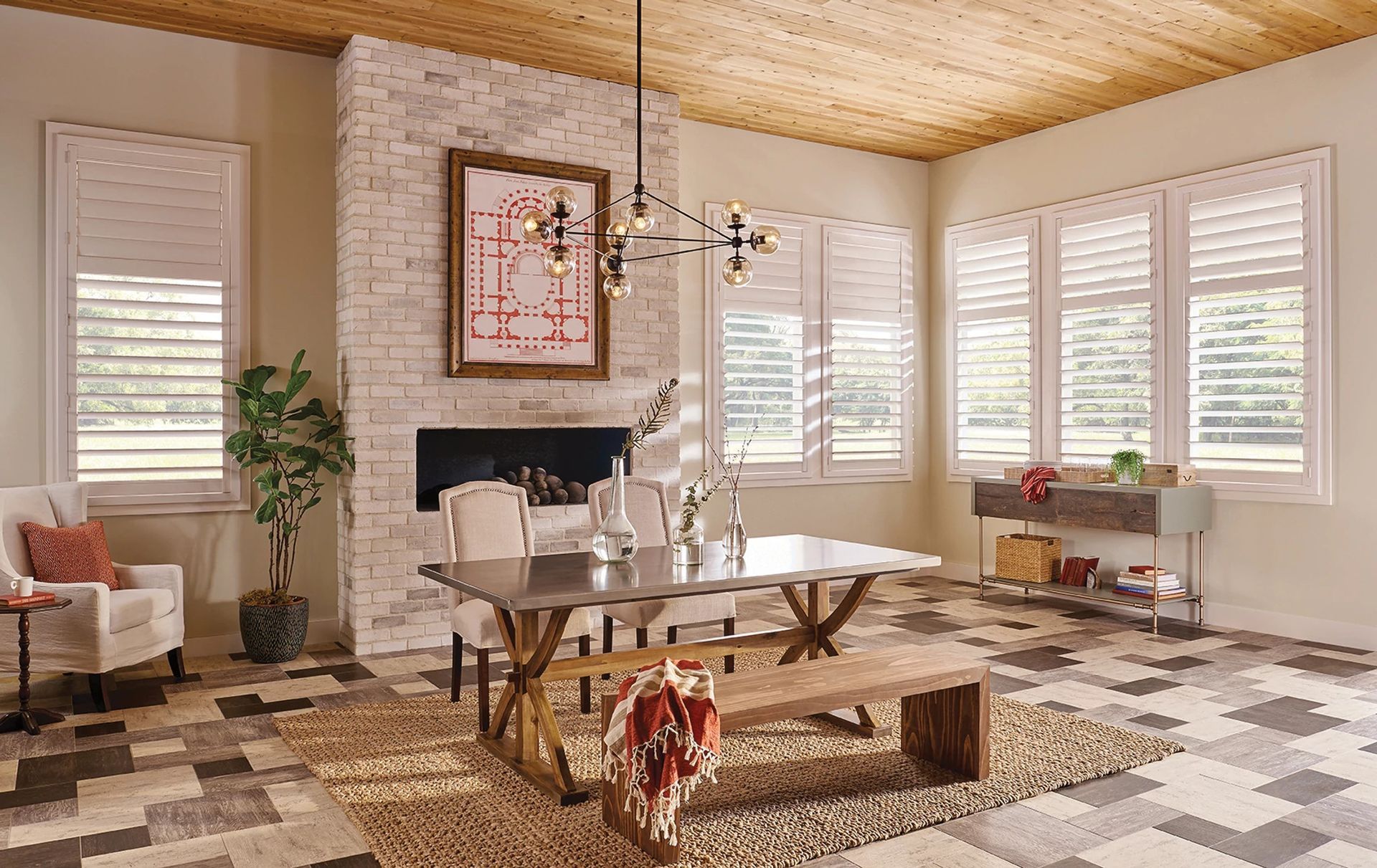 A dining room with a table and chairs and a fireplace.