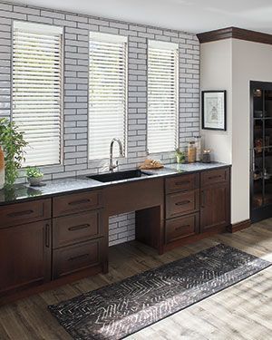 a bathroom with faux wood blinds