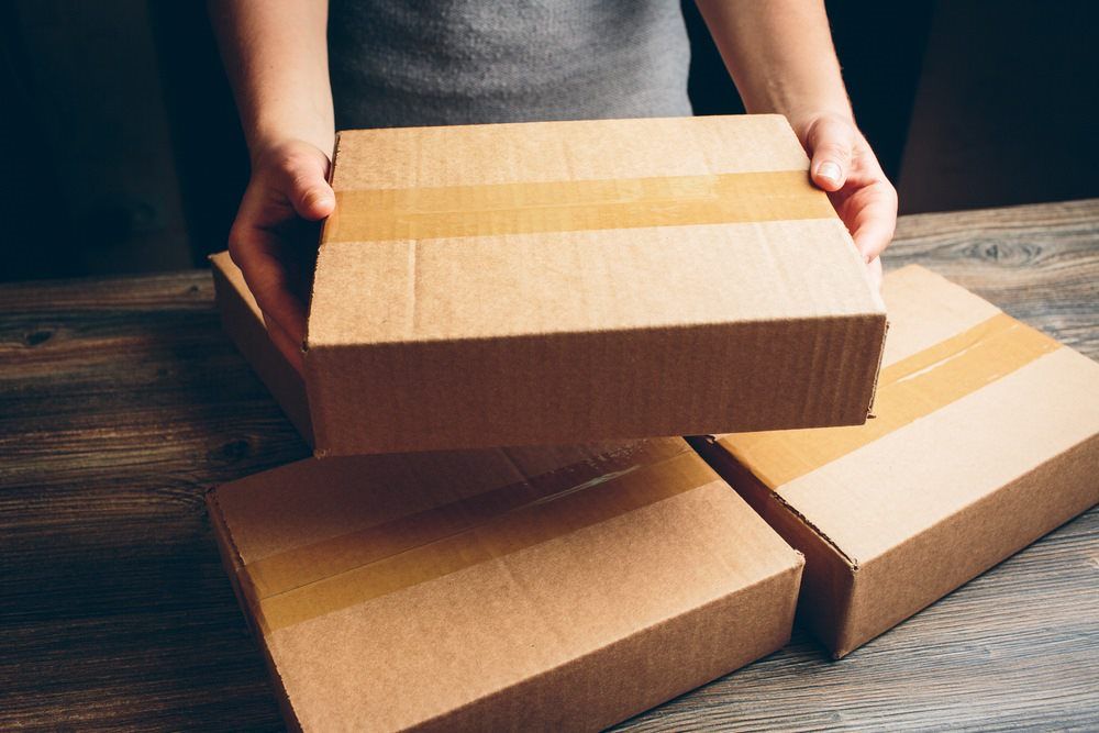 Man Organizing Boxes — Printing Services in Coffs Harbour, NSW