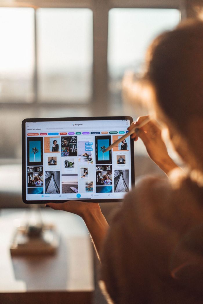 Woman Checking Designs On Tablet — Printing Services in Coffs Harbour, NSW