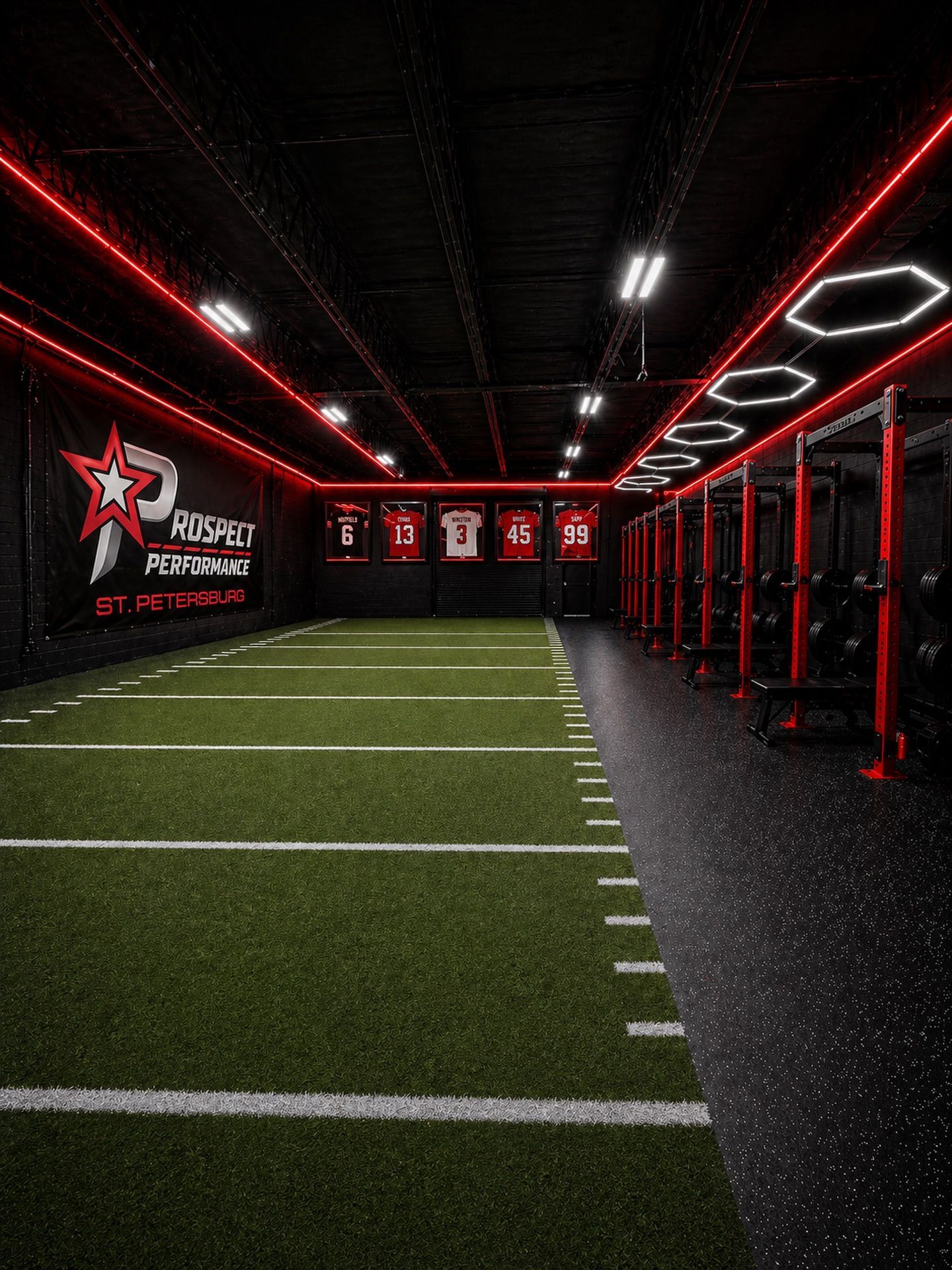 Red-lit indoor football training tunnel with turf field, black walls, and star logo branding on the left.