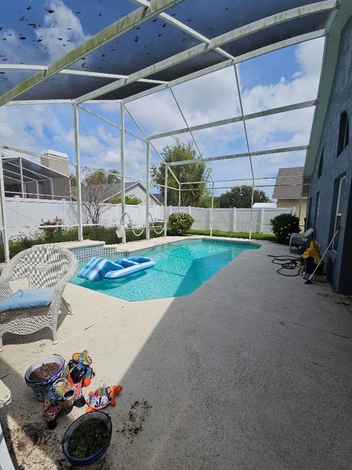 Dirty pool cage and deck with pollen and algae buildup in Riverview