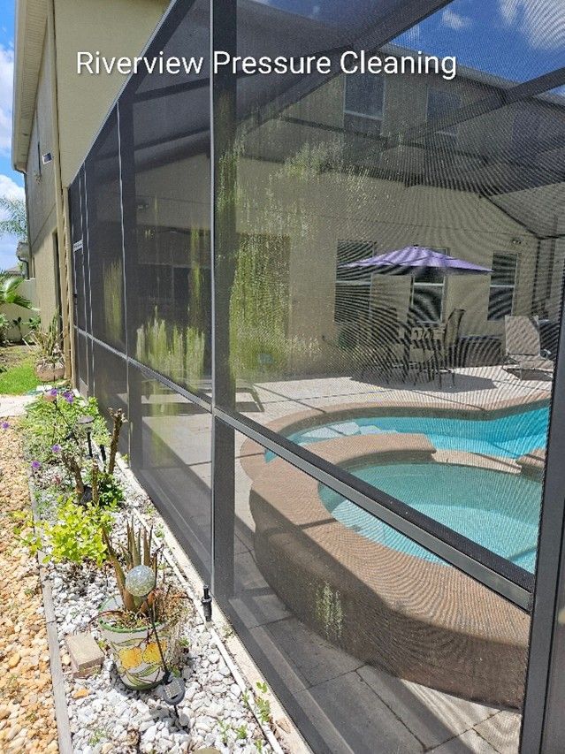 Clean pool cage screens and travertine deck after pressure washing in Riverview