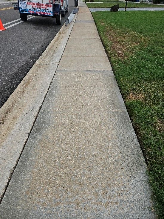 Clean painted driveway and bright concrete sidewalks after pressure washing in Sun City Center